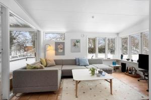 a living room with a couch and a table at LL267-Tranekaer-Bellisvej-2 in Stoense