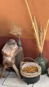 a table with two vases and a basket of peanuts at Chill Atacama in San Pedro de Atacama