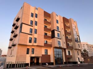 aartment building with a brown building at شقة قباء in Medina