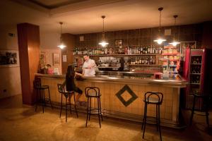 a man and a woman standing at a bar at Hotel Beri in Llança
