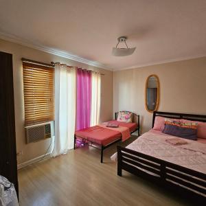 a bedroom with two beds and a window at One oasis condo 1bedroom Ltype in Davao City