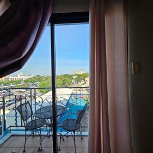 a balcony with chairs and a view of a pool at One oasis condo 1bedroom Ltype in Davao City