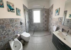 a white bathroom with a sink and a toilet at Lux Maris in Mazara del Vallo +24 photos