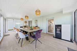 a kitchen and dining room with a table and chairs at L'écrin fleuri in Allerey