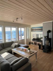 a living room with a couch and a table at Sauna & Mountain Views - Ski-in Ski-out Luxury in Vossevangen