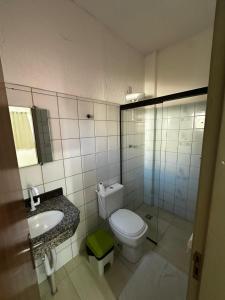 a bathroom with a white toilet and a sink at Pousada Salomão in Teixeira de Freitas +31 photos