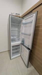 an empty refrigerator with its door open in a room at Chez Lucia petite maison a la campagne pour 4 pers ,parking prive in Istres