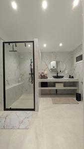 a bathroom with a mirror and a tub and a sink at Chez Lucia petite maison a la campagne pour 4 pers ,parking prive in Istres +22 photos