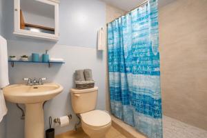 a bathroom with a toilet and a sink at Dorado Costa De Oro Beach 2 Bedroom Oceanfront by Rentalspr in Dorado