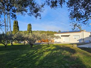 a house in a field with trees in the background at Chez Lucia petite maison a la campagne pour 4 pers ,parking prive in Istres