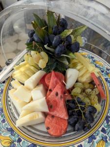 a plate of fruit and vegetables on a table at Oasi Del Gabbiano in Syracuse