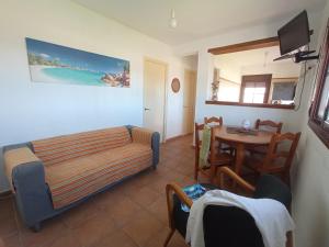 a living room with a couch and a table at BOL16 in Bolonia