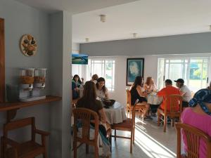 a group of people sitting at tables in a restaurant at Clima Termal Suites in Federación