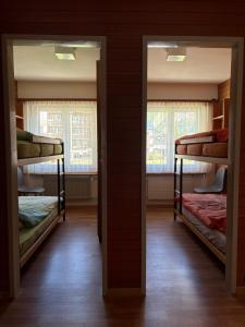 two bunk beds in a room with two windows at Salü 5 in Saas-Fee