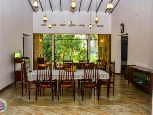 a dining room with a table and chairs at Mount Lily Mirissa in Mirissa