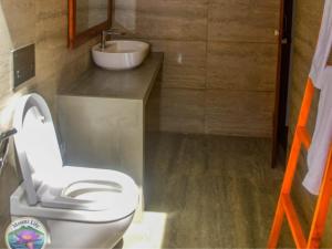 a bathroom with a toilet and a sink at Mount Lily Mirissa in Mirissa
