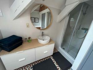 a bathroom with a sink and a shower with a mirror at L'arche De Noé in Dinant +90 photos