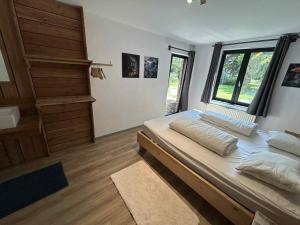 a bedroom with a large bed and a window at L'arche De Noé in Dinant