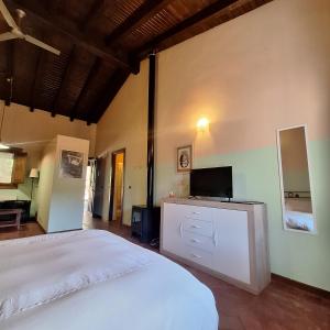 a bedroom with a bed and a tv on a dresser at Apartamentos Casasturga in Collado +46 photos