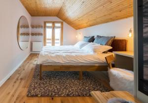 a bedroom with a large bed with a wooden ceiling at Heritage Villa Predelut - Fireplace & Baby Crib in Predeluţ