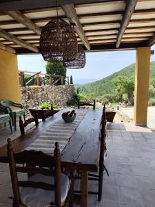 a wooden table on a patio with a view at Casatona in San Mateo de Bages