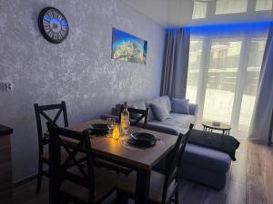 a living room with a table and a couch at Mostique Spa Apartment with Jacuzzi in Gdańsk