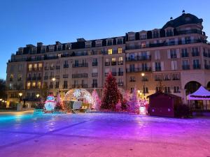 a christmas tree and lights in front of a building at Paris Saint Maurice Montgolfier in Saint-Maurice