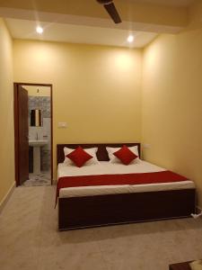 a bedroom with a large bed with red pillows at Chill with pahadi in Lansdowne