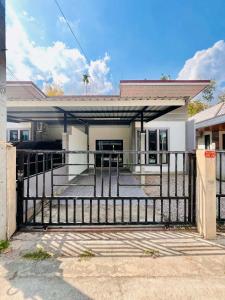a house with a gate in front of it at Comfort Home stay Private Room A Shared House in Ban Tha Khun