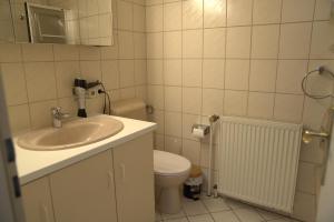 a bathroom with a sink and a toilet at Hotel Bentheimer Eck in Bad Bentheim +21 photos
