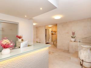 a kitchen with a counter with flowers in a room at Hotel Punta San Francesco in Vieste +55 photos