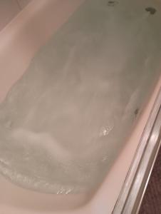 a bath tub filled with lots of water at Poplar Estate in Lincoln +18 photos