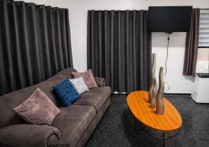 a living room with a couch and a table at Dorado Costa De Oro Beach 2 Bedroom Oceanfront by Rentalspr in Dorado