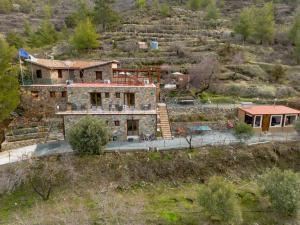 an aerial view of a house in a field at Fikardou Chalets in Phikardhou