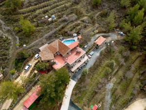 an aerial view of a house with a swimming pool at Fikardou Chalets in Phikardhou
