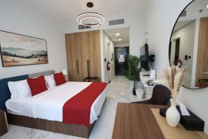 a hotel room with a bed and a desk at Modern Waterfront Studio | Steps from Cleveland Clinic in Abu Dhabi +29 photos
