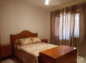 a bedroom with a bed with a table and a window at Casa Guevara in San Rafael