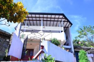 a house with a solarium on the side of it at Kandyan White Holiday Homes in Kandy