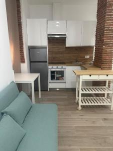 a kitchen with a couch and a table in a room at La Casa de Mara in Madrid +11 photos