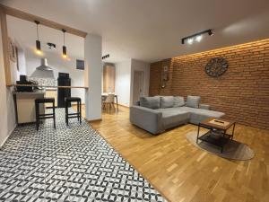 a living room with a couch and a brick wall at Casa Aluna Duo in Bran +61 photos