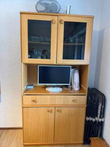 a wooden cabinet with a computer on top of it at Casa Vacanze S&B in Viola +4 photos