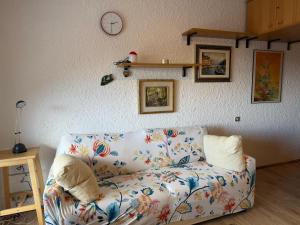 a living room with a couch and a clock on the wall at Casa Vacanze S&B in Viola