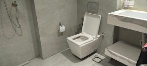 a bathroom with a toilet and a shower and a sink at شارع الاربعين حديقه بدر in Cairo