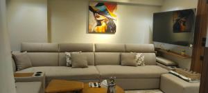 a living room with a couch and a flat screen tv at شارع الاربعين حديقه بدر in Cairo