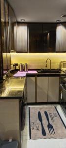 a kitchen with a sign with utensils on it at شارع الاربعين حديقه بدر in Cairo +17 photos