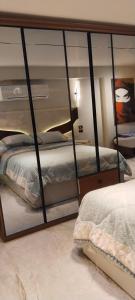 a bedroom with two bunk beds and a mirror at شارع الاربعين حديقه بدر in Cairo