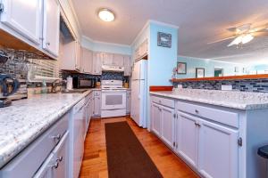 a kitchen with white cabinets and white appliances at Landing Pad - Kill Devil Hills, Oceanside, 350 Yards to Beach, Flex Stays, 4 BR in Kill Devil Hills