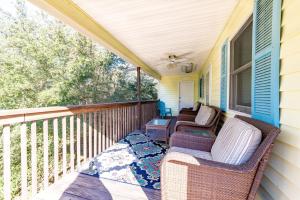 a porch with two chairs and a table on it at Landing Pad - Kill Devil Hills, Oceanside, 350 Yards to Beach, Flex Stays, 4 BR in Kill Devil Hills