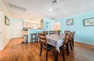 a dining room and kitchen with a table and chairs at Landing Pad - Kill Devil Hills, Oceanside, 350 Yards to Beach, Flex Stays, 4 BR in Kill Devil Hills