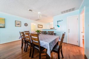 a dining room with a table and chairs at Landing Pad - Kill Devil Hills, Oceanside, 350 Yards to Beach, Flex Stays, 4 BR in Kill Devil Hills +33 photos